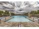 Outdoor swimming pool surrounded by lounge chairs and umbrellas, ideal for relaxation and leisure at 208 Coltrane Canyon Ave, Henderson, NV 89011