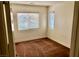 Bedroom featuring neutral walls, carpet flooring, and natural light from two windows at 224 Wicked Wedge Way, Las Vegas, NV 89148