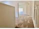 Upstairs hallway featuring plush carpeting and a glimpse into an open room with natural light at 224 Wicked Wedge Way, Las Vegas, NV 89148