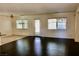 Spacious living room with dark wood floors and a sliding glass door for backyard access at 224 Wicked Wedge Way, Las Vegas, NV 89148