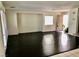 Open living room features dark floors, white walls, and large windows at 224 Wicked Wedge Way, Las Vegas, NV 89148