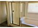 Bathroom with a shower featuring glass enclosure and tub with a window for natural light at 224 Wicked Wedge Way, Las Vegas, NV 89148