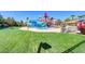 Community water park featuring colorful slides, tables, chairs, and green lawns for residents and guests to enjoy at 224 Wicked Wedge Way, Las Vegas, NV 89148
