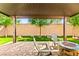 Inviting backyard patio with fire pit, pavers, mature trees and artificial grass at 2333 Mundare Dr, Henderson, NV 89002