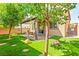 View of the outdoor living space with patio cover, pavers, and professionally installed artificial turf at 2333 Mundare Dr, Henderson, NV 89002