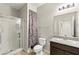 Well-lit bathroom with a shower, neutral color scheme, and granite countertop at 2333 Mundare Dr, Henderson, NV 89002