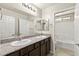 Granite-topped vanity with double sinks and updated fixtures highlight this bright, clean bathroom at 2333 Mundare Dr, Henderson, NV 89002