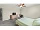 Comfortable bedroom features a ceiling fan, dresser with television, and a work space at 2333 Mundare Dr, Henderson, NV 89002