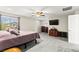 Carpeted primary bedroom with large windows, a ceiling fan, and entertainment center at 2333 Mundare Dr, Henderson, NV 89002