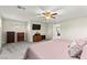 Spacious primary bedroom featuring a ceiling fan, soft carpet, and ambient natural light at 2333 Mundare Dr, Henderson, NV 89002