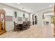 Bright dining room with natural lighting, tiled floors, and an archway to the kitchen at 2333 Mundare Dr, Henderson, NV 89002