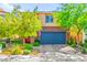 Charming two-story home featuring a blue garage door, a red entry door, and well-maintained landscaping at 2333 Mundare Dr, Henderson, NV 89002