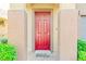 Close-up of the front door featuring a red door, stone columns, and a welcoming entrance at 2333 Mundare Dr, Henderson, NV 89002