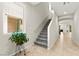 Hallway featuring tile floors, stairs to the second floor, and natural light from the window at 2333 Mundare Dr, Henderson, NV 89002