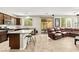 Open-concept kitchen featuring granite countertops, a central island with seating, and modern appliances at 2333 Mundare Dr, Henderson, NV 89002