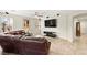 Comfortable living room with a large sectional sofa, ceiling fan, and a mounted TV for entertainment at 2333 Mundare Dr, Henderson, NV 89002