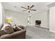 Upstairs living area with soft carpet, comfortable sofa, natural light, and ceiling fan at 2333 Mundare Dr, Henderson, NV 89002