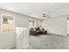 Upstairs loft area with carpet, comfortable sofa, natural light, and ceiling fan at 2333 Mundare Dr, Henderson, NV 89002