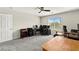 Office featuring a ceiling fan, large window, multiple desks and a door at 2333 Mundare Dr, Henderson, NV 89002
