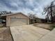 Single story house with a two car garage and a long driveway at 2450 Oak Glen Way, Las Vegas, NV 89115