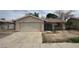 Single story house with a two car garage and a gated front courtyard in need of some TLC at 2450 Oak Glen Way, Las Vegas, NV 89115