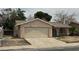 Single story house with a two car garage and a gated front courtyard at 2450 Oak Glen Way, Las Vegas, NV 89115