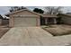 Exterior of a single-story home with garage and gated window coverings, front yard space at 2450 Oak Glen Way, Las Vegas, NV 89115
