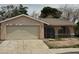 Single story house with a two car garage and gated front porch in need of some TLC at 2450 Oak Glen Way, Las Vegas, NV 89115