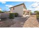Backyard showcasing gravel ground cover, and covered patio extending from the rear of the house at 2608 Campobello Ave, North Las Vegas, NV 89081