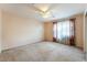 Neutral bedroom with carpet flooring, ceiling fan, and window with sheer drapes at 2608 Campobello Ave, North Las Vegas, NV 89081