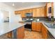 Kitchen features wooden cabinets, stone backsplash, and a central island at 2608 Campobello Ave, North Las Vegas, NV 89081