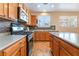 The kitchen features wooden cabinets, stainless steel appliances, and stone backsplash at 2608 Campobello Ave, North Las Vegas, NV 89081