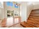 Hardwood floor living room featuring a staircase and natural lighting from sliding glass doors at 2608 Campobello Ave, North Las Vegas, NV 89081