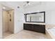 Bright bathroom featuring double sinks, large mirror, soaking tub and tiled shower at 2777 Paradise Rd # 303, Las Vegas, NV 89109