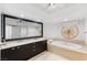 Bright bathroom featuring double sinks, large mirror, and a soaking tub at 2777 Paradise Rd # 303, Las Vegas, NV 89109