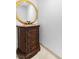 A powder room showcasing an elegant round mirror above a beautiful wooden vanity with marble countertop at 2777 Paradise Rd # 303, Las Vegas, NV 89109