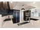Stylish kitchen featuring black cabinets, gas range, a large refrigerator, and quartz counters at 2777 Paradise Rd # 303, Las Vegas, NV 89109