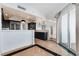 Open concept kitchen with black cabinets, stainless fridge, and view to the living room at 2777 Paradise Rd # 303, Las Vegas, NV 89109