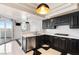 Modern kitchen with sleek black cabinetry, stainless steel appliances, and quartz countertops at 2777 Paradise Rd # 303, Las Vegas, NV 89109