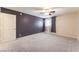 Large carpeted bedroom with ceiling fan, ample natural light, and a statement wall at 2866 Loveland Dr # 2018, Las Vegas, NV 89109