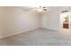 Bright bedroom with neutral carpet, ceiling fan, and a view into an en-suite bathroom at 2866 Loveland Dr # 2018, Las Vegas, NV 89109