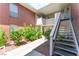 Exterior view of condo with stairs leading to the upper level with well-maintained landscaping at 2866 Loveland Dr # 2018, Las Vegas, NV 89109