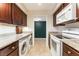 Galley style kitchen boasts granite countertops, white appliances, and stacked washer and dryer at 2866 Loveland Dr # 2018, Las Vegas, NV 89109