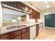 Kitchen with granite countertops, under cabinet lighting, stainless sink, dishwasher, and stacked laundry units at 2866 Loveland Dr # 2018, Las Vegas, NV 89109