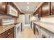 Galley style kitchen features granite countertops, white appliances, and stacked washer and dryer at 2866 Loveland Dr # 2018, Las Vegas, NV 89109
