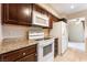 Bright kitchen features white appliances, granite countertops, and dark wood cabinets at 2866 Loveland Dr # 2018, Las Vegas, NV 89109
