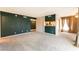 Spacious living room with modern gray carpet, dark accent wall, and seamless transition to other spaces at 2866 Loveland Dr # 2018, Las Vegas, NV 89109