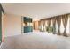 Spacious living room with plush carpet, a bar area, and an abundance of natural light at 2866 Loveland Dr # 2018, Las Vegas, NV 89109