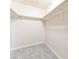 Walk-in closet with carpet, built-in shelving, and wooden rods for ample storage at 2866 Loveland Dr # 2018, Las Vegas, NV 89109