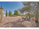 Large backyard area with decorative gravel and patio with four chairs at 3104 Hayden Ct, Las Vegas, NV 89134